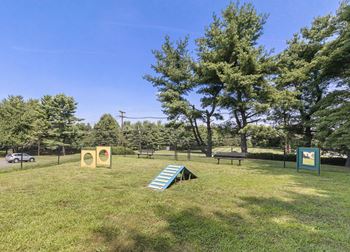A playground with a slide and two yellow signs.